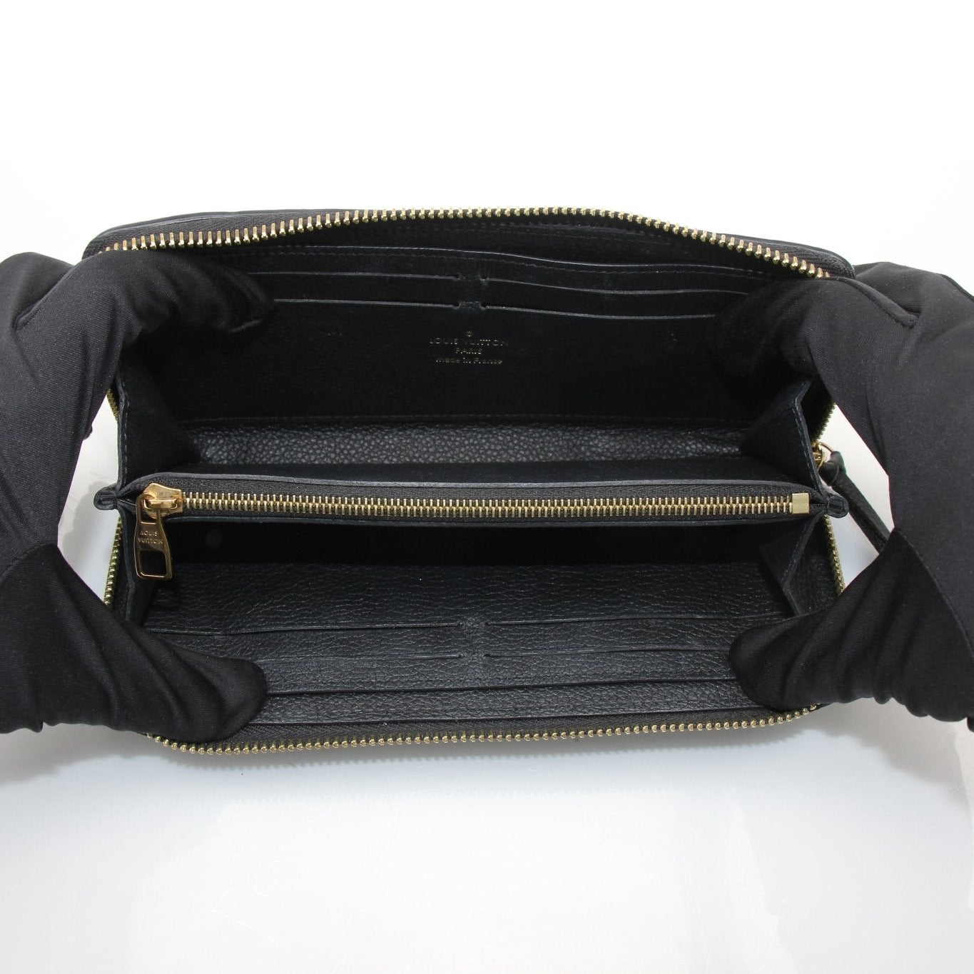 Louis Vuitton Clemence Empreinte wallet by Gold & Beyond, featuring textured leather with gold-tone hardware and multiple card slots.