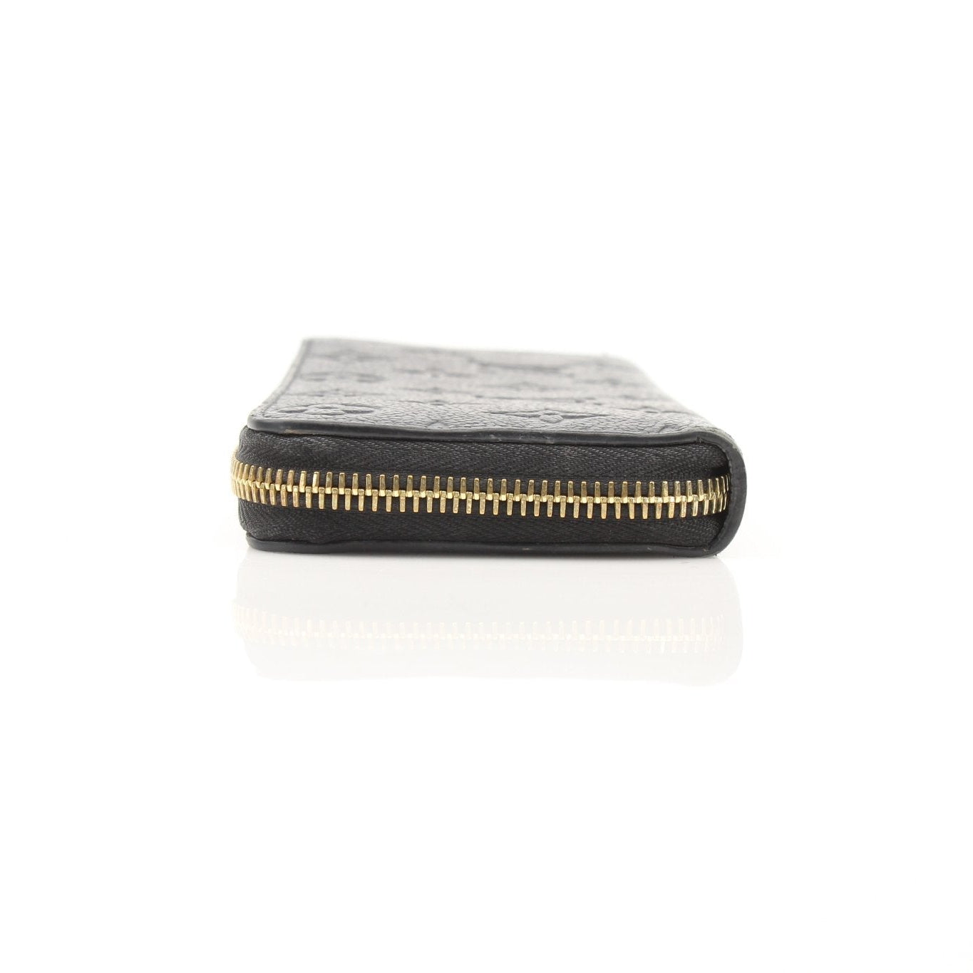 Gold & Beyond Louis Vuitton Clemence Empreinte wallet showing embossed leather texture and gold-toned hardware.