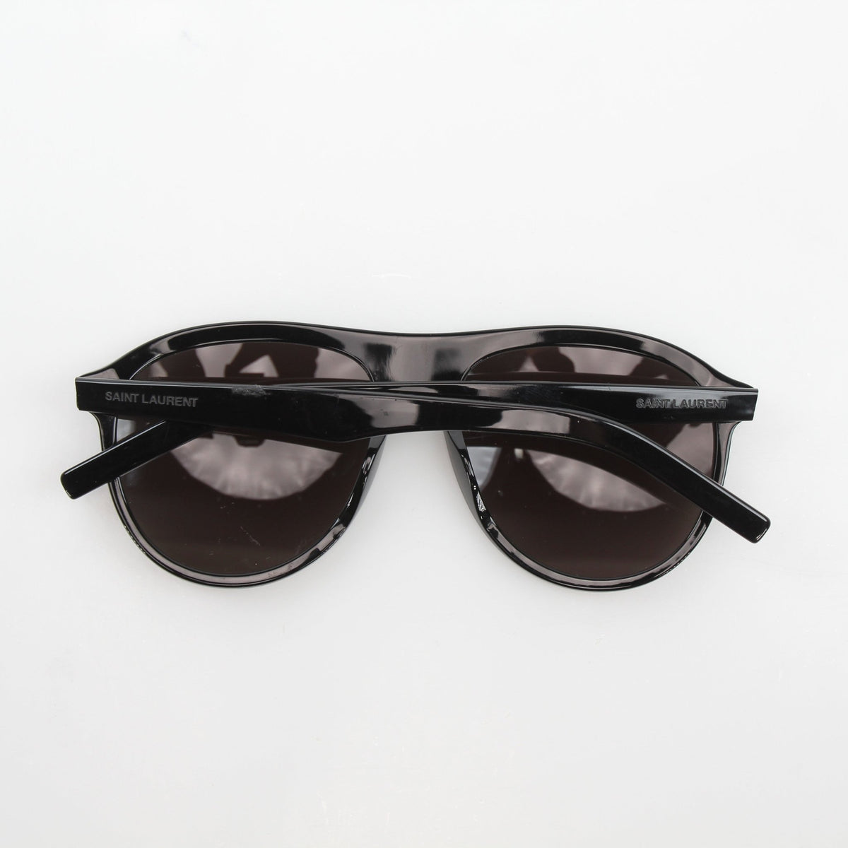 Black Saint Laurent SL 432 Slim Pilot sunglasses with gold accents, stylish accessories for a modern, sophisticated look.