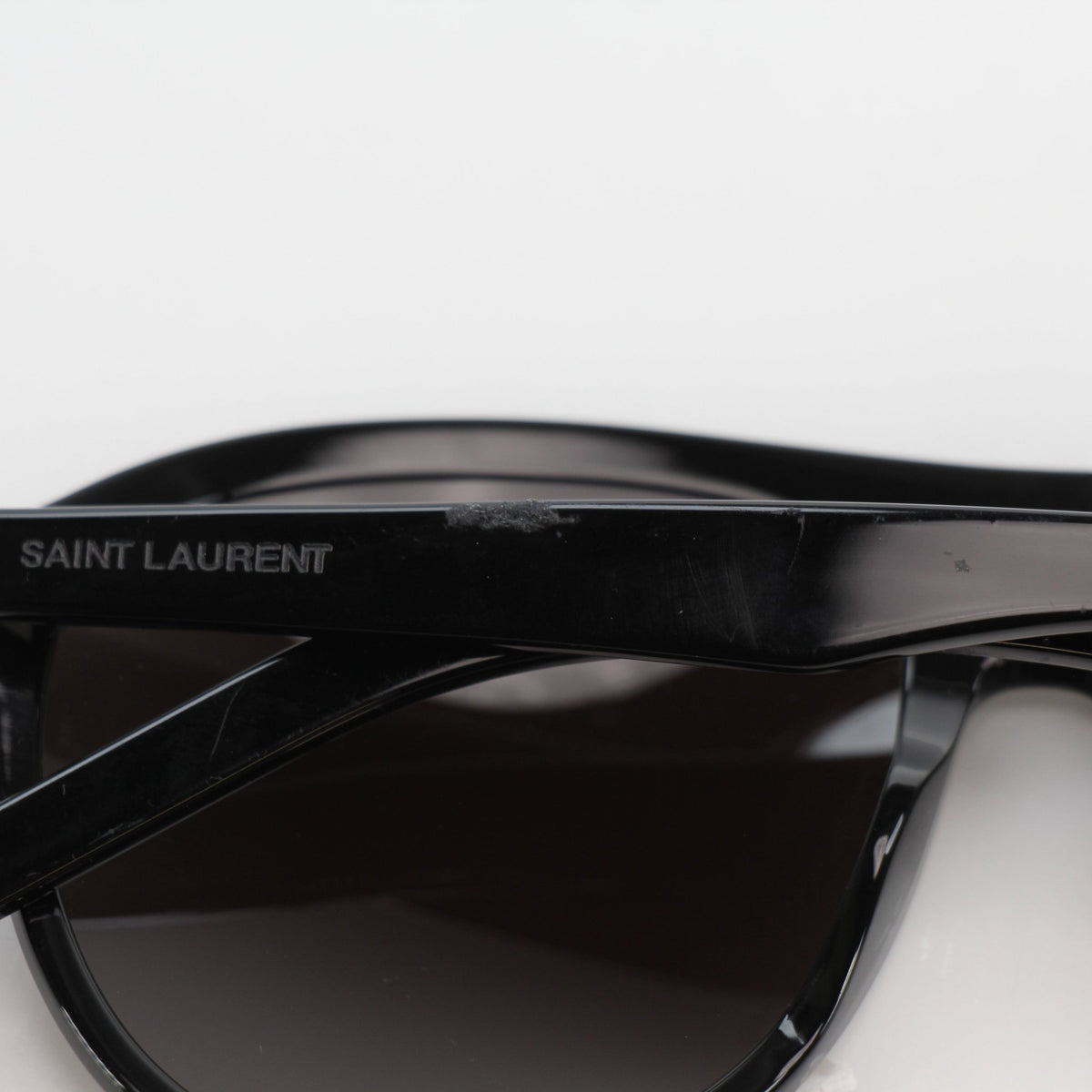 Black Saint Laurent SL 432 Slim Pilot sunglasses with gold accents, displayed on a plain background.
