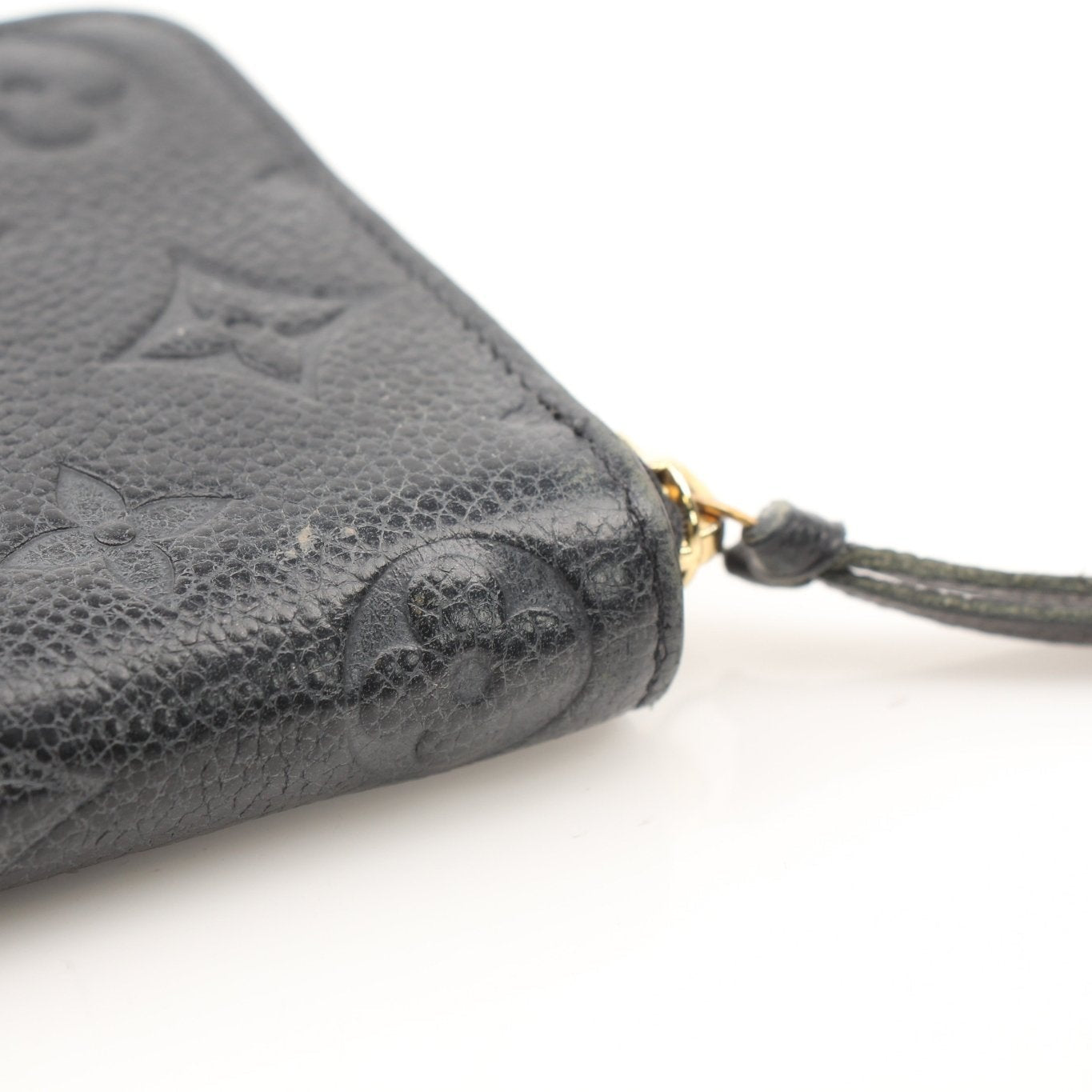 Louis Vuitton Clemence Empreinte wallet with gold-toned hardware and embossed leather exterior, open to reveal card slots and interior compartments.