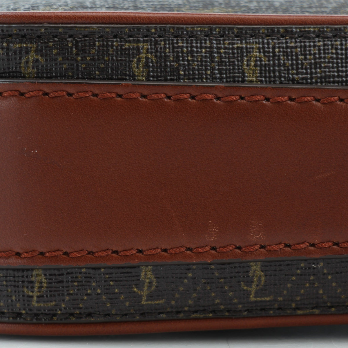 Brown Saint Laurent Le Monogramme crossbody pouch handbag with gold hardware and adjustable strap.