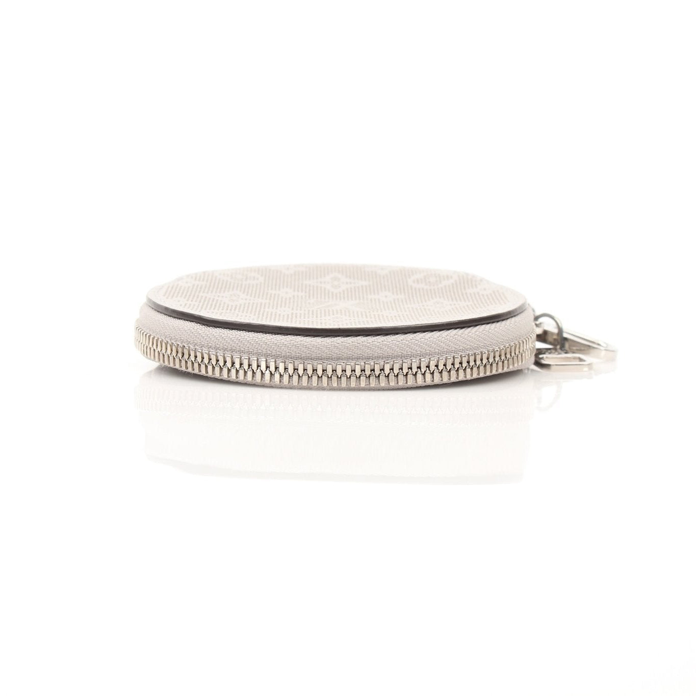 Louis Vuitton gray round bag charm accessory with gold accents, featuring a sleek, stylish design for handbags and luggage.