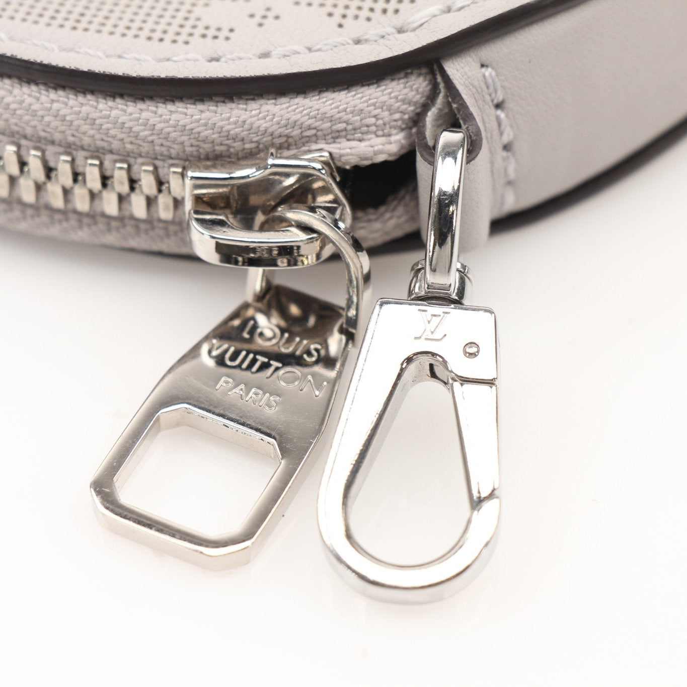Louis Vuitton gray round bag charm accessory with gold accents, designed for stylish handbags and luxury accessories.