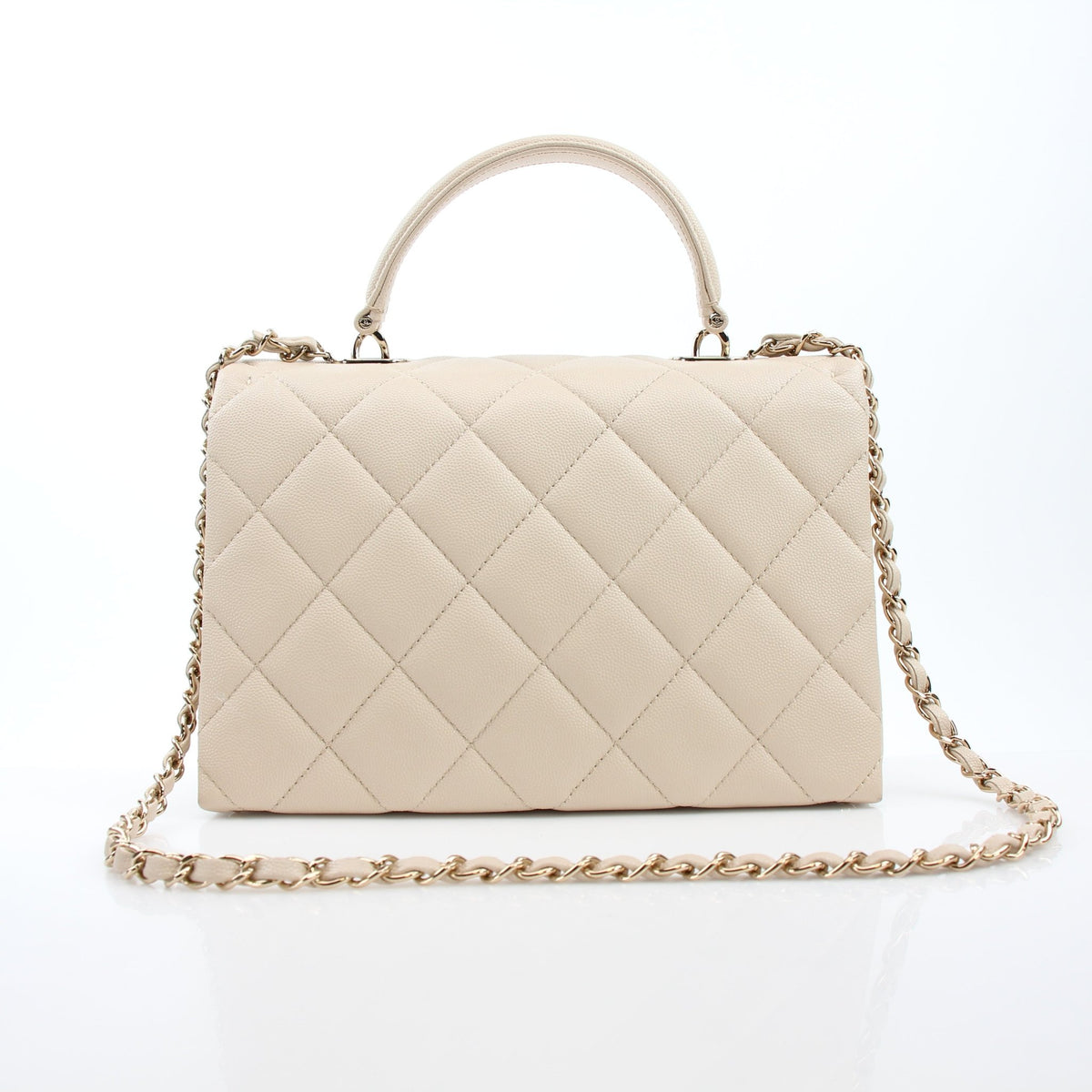 Beige Chanel mini flap bag with top handle and retro twist by Gold & Beyond