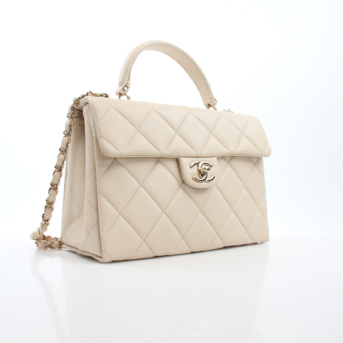 Beige Chanel mini flap handbag with top handle and retro twist design by Gold & Beyond