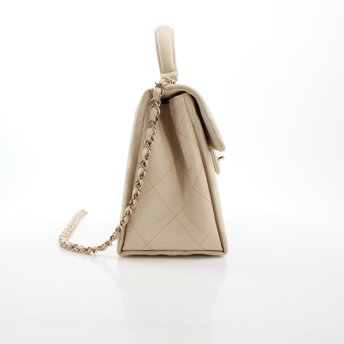 Beige Chanel Mini Flap Bag with Top Handle and Retro Twist design in compact handbag style