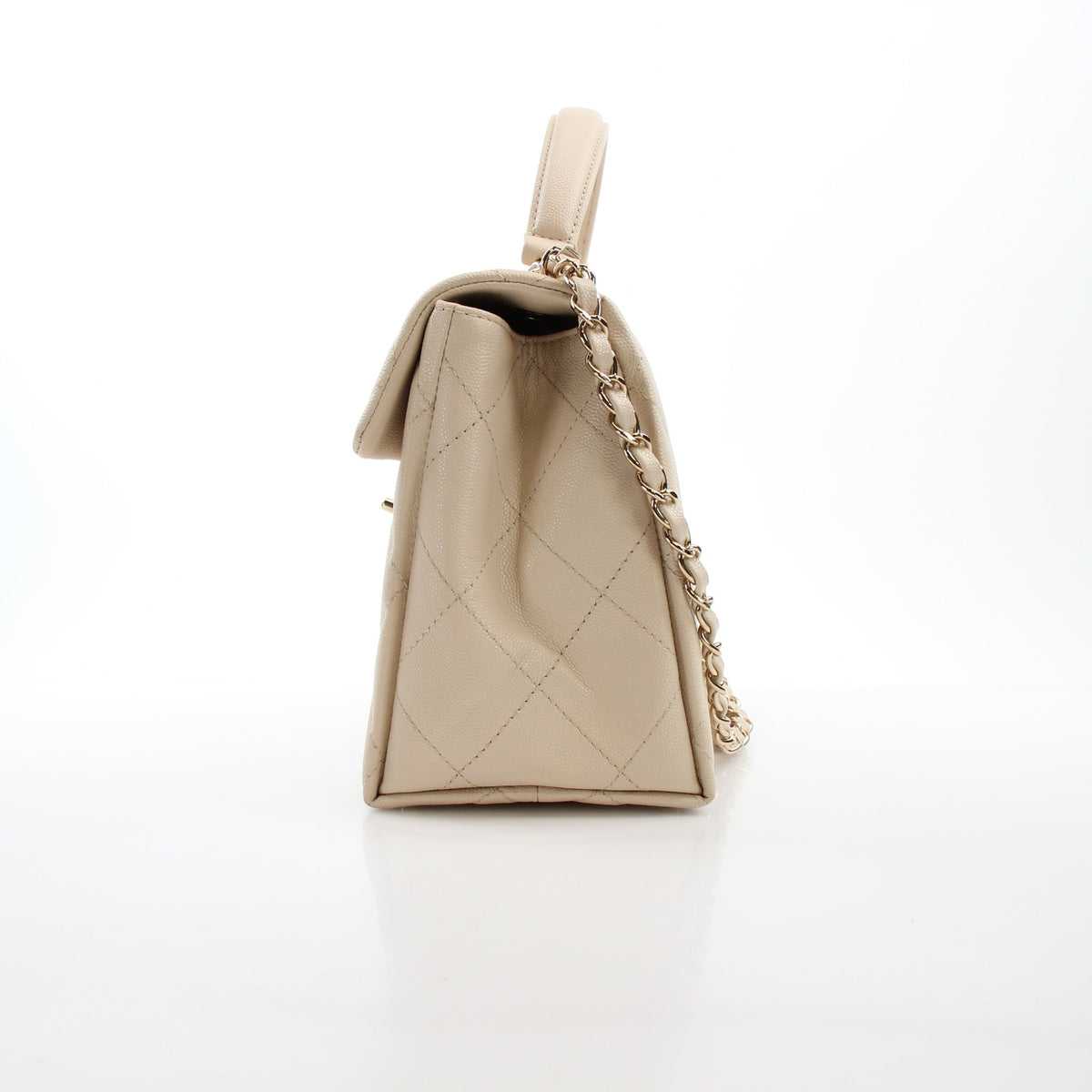 Beige Chanel Mini Flap Bag with top handle and retro twist design, handbag by Gold & Beyond