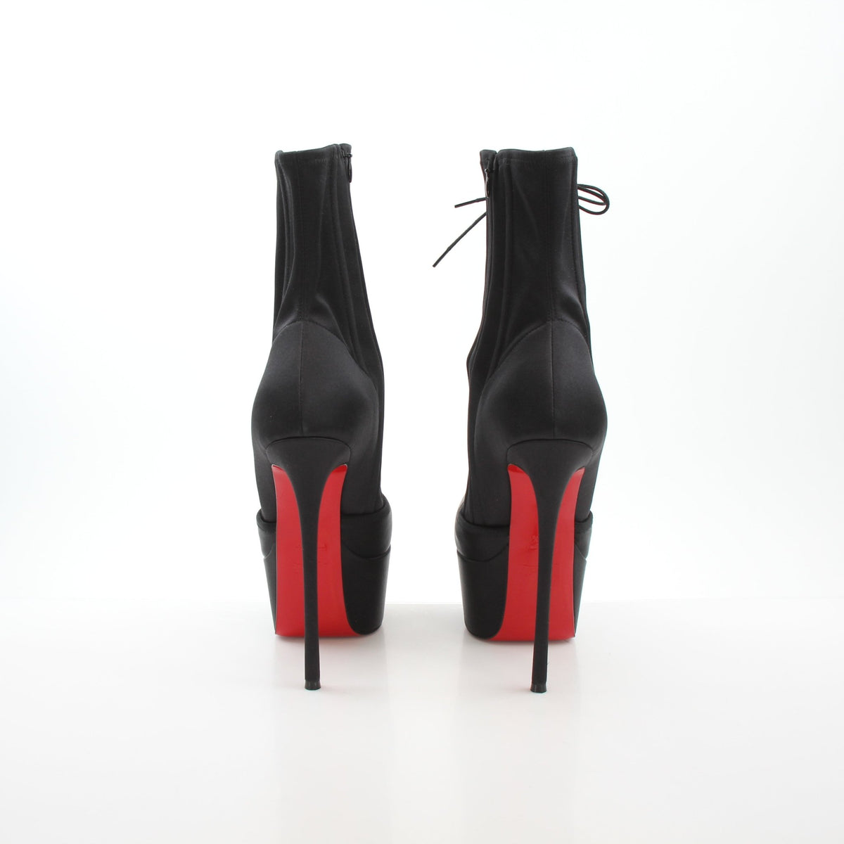 Christian Louboutin Pavlova Booty Alta black satin platform heels with high stiletto heels and sleek design.