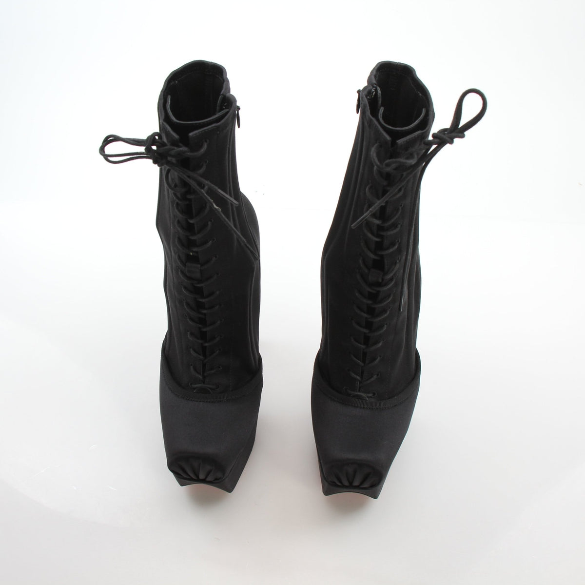 Christian Louboutin Pavlova Booty Alta black satin platform heels with high stiletto heels and sleek design.