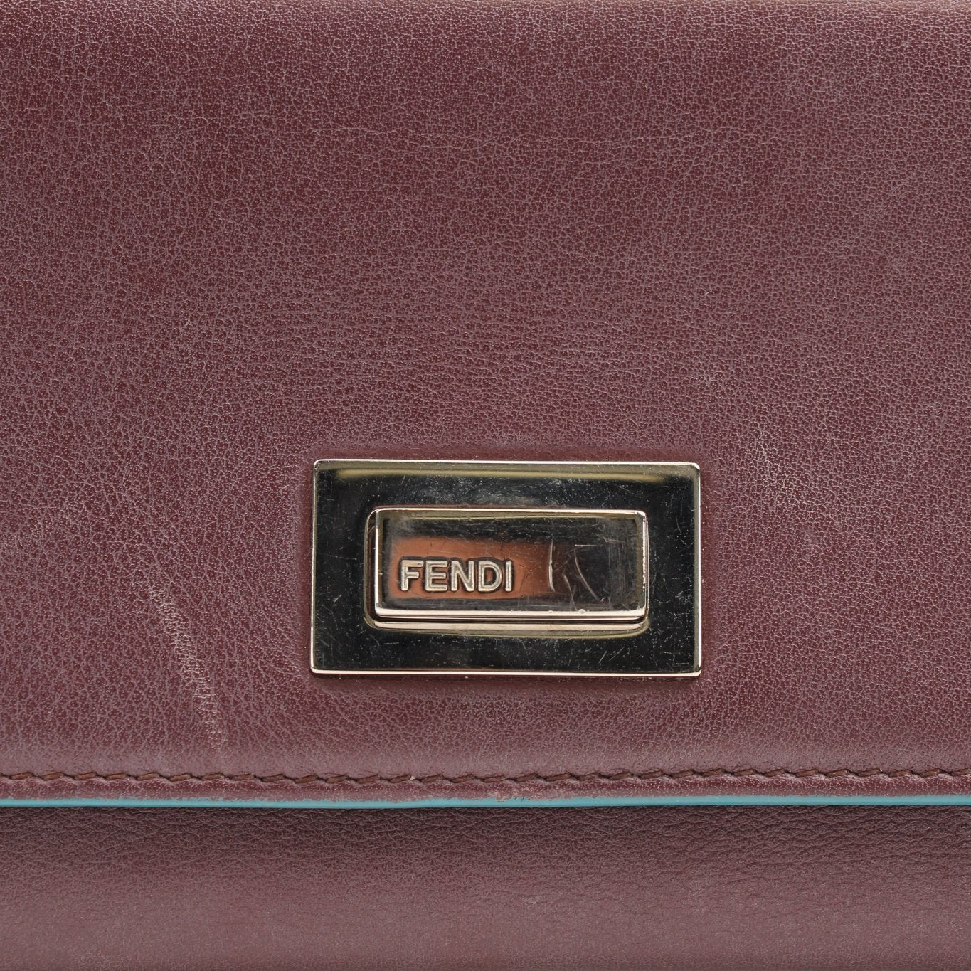 Fendi Burgundy Continental Wallet with gold accents, showcasing its sleek design and high-quality leather material.