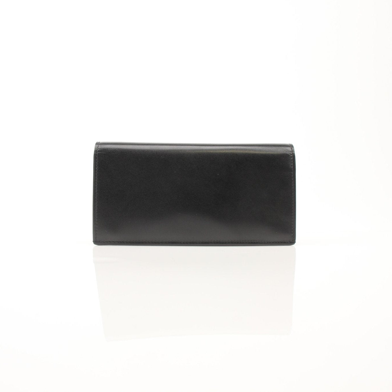 Black Saint Laurent Monogram YSL flap wallet with gold hardware and sleek design, showcasing the luxurious leather exterior.