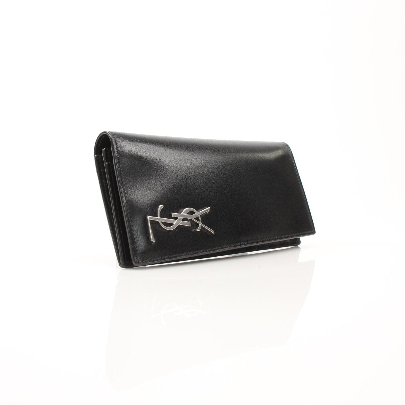 Saint Laurent Monogram YSL black flap wallet with gold branding and textured leather, shown open with card slots and interior details.