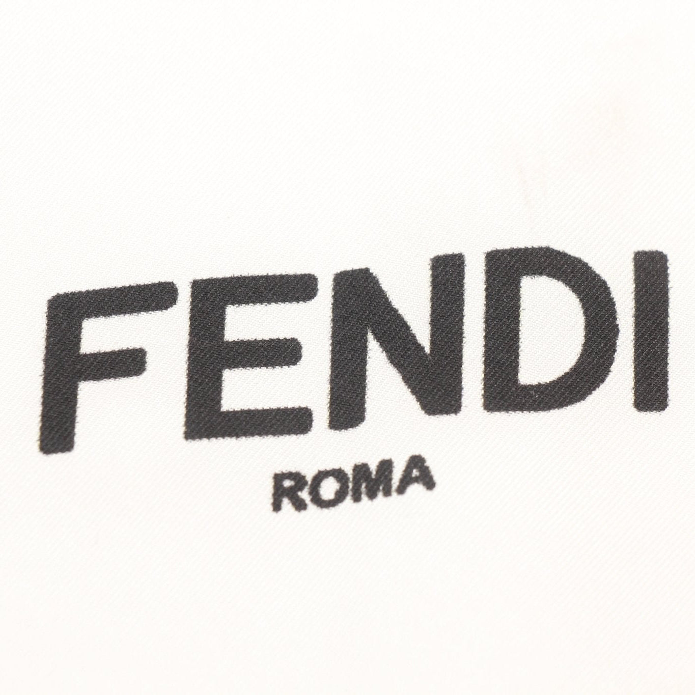 White silk scarf with Fendi “King Demon” design, luxury accessories by Gold & Beyond, featuring intricate pattern and elegant fabric.
