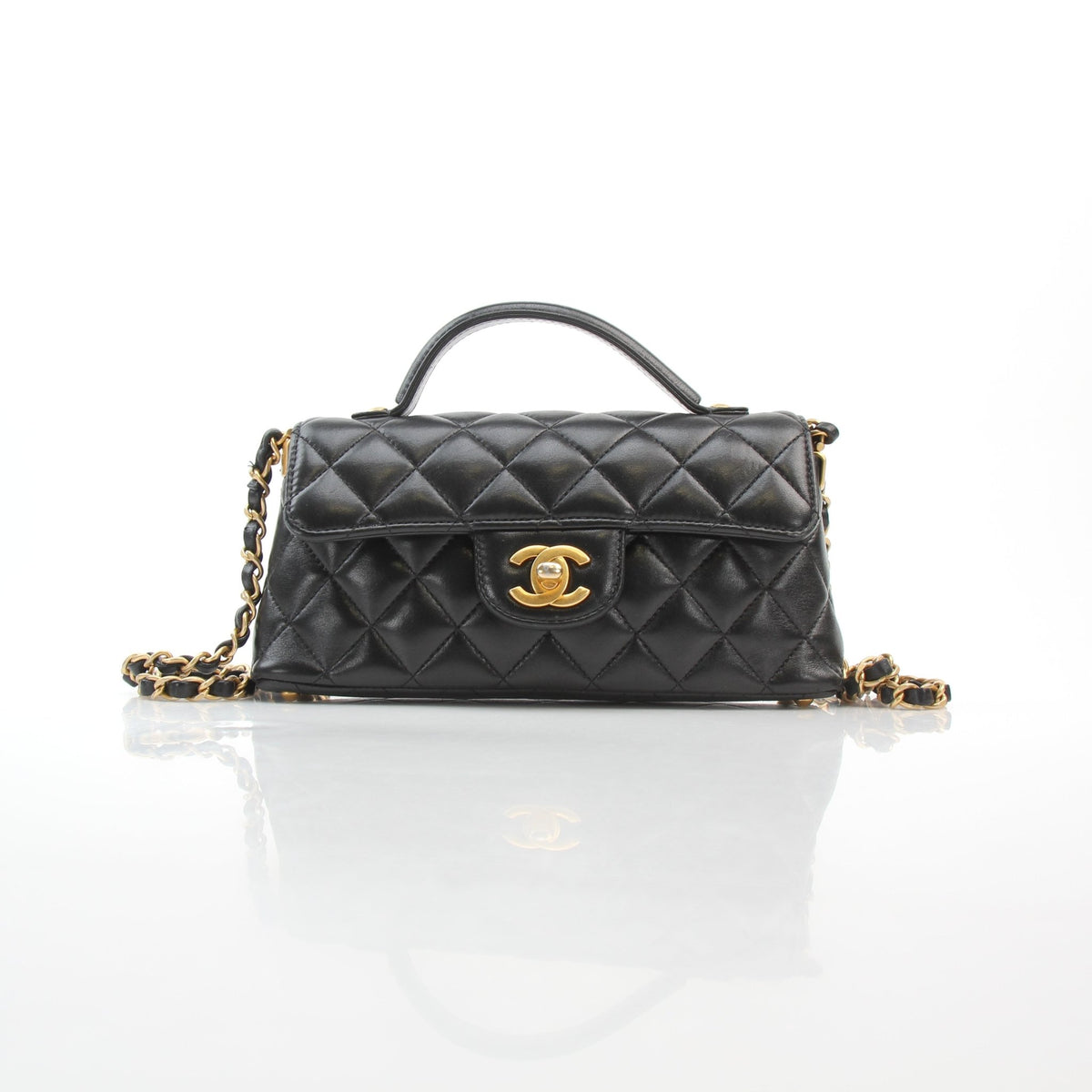 Chanel black lambskin mini flap handbag with top handle and gold-tone hardware