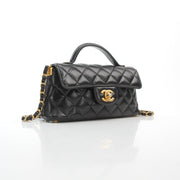 Chanel black lambskin mini flap bag with top handle handbag in polished leather, front view