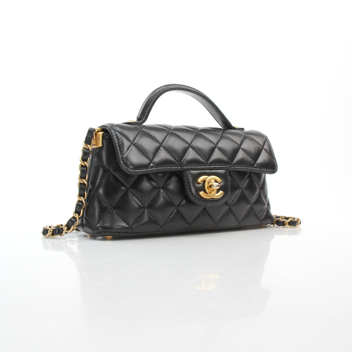 Chanel black lambskin mini flap bag with top handle handbag in polished leather, front view