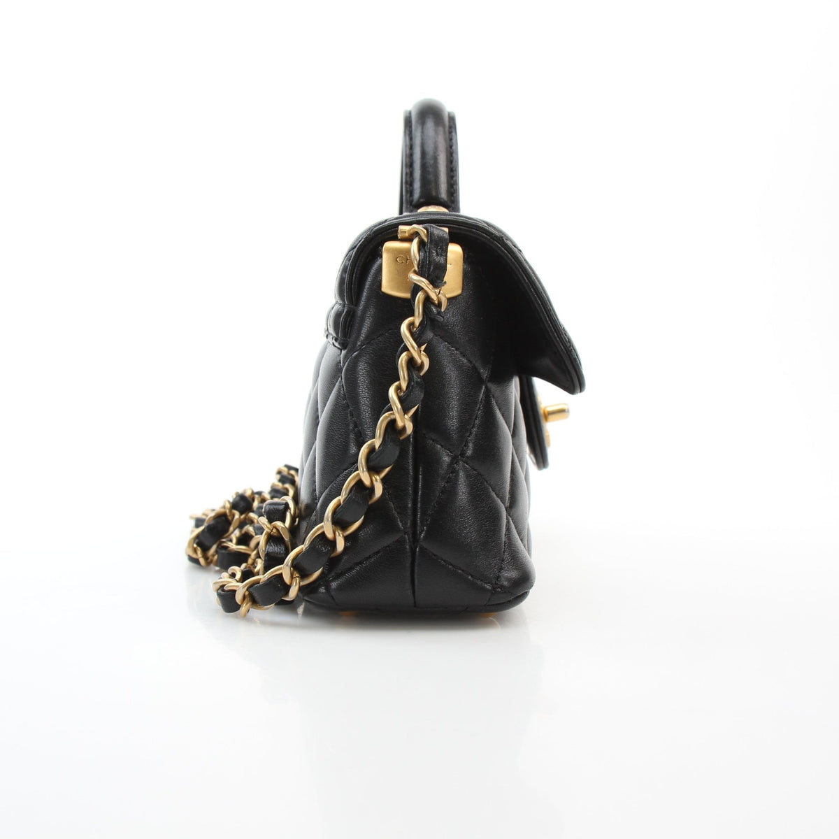 Chanel black lambskin mini flap handbag with top handle, shown by Gold & Beyond