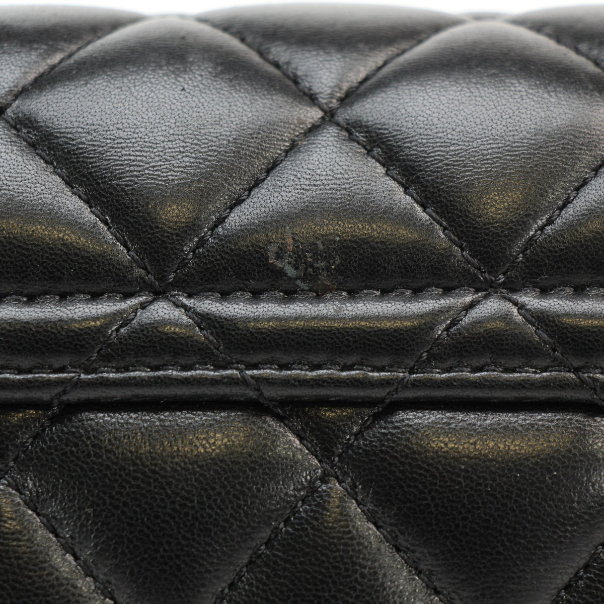 Chanel black lambskin mini flap bag with top handle, structured silhouette and quilted finish