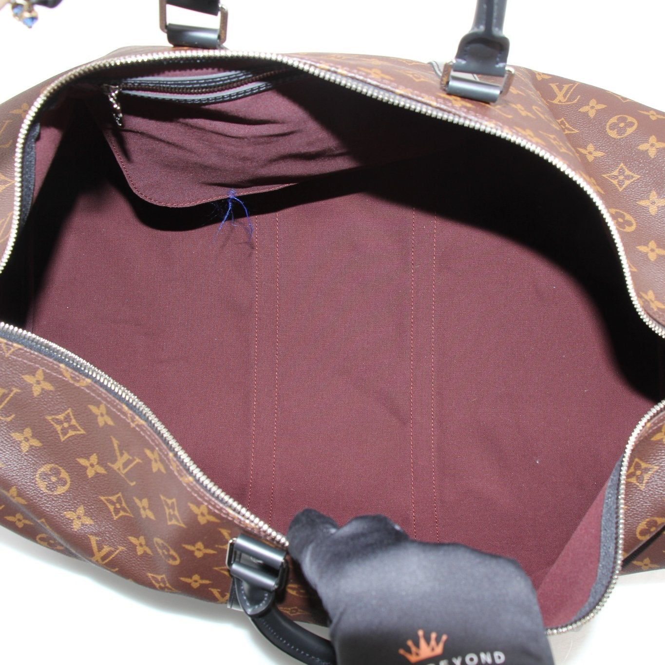 Gold & Beyond Louis Vuitton Keepall Bandoulière 55 travel bag in classic brown monogram canvas with leather accents.