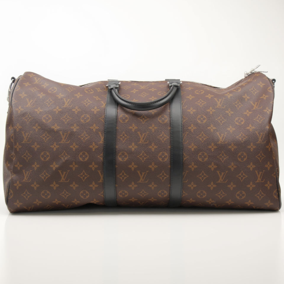 Louis Vuitton Keepall Bandoulière 55 travel bag in classic monogram canvas with leather trim and shoulder strap.