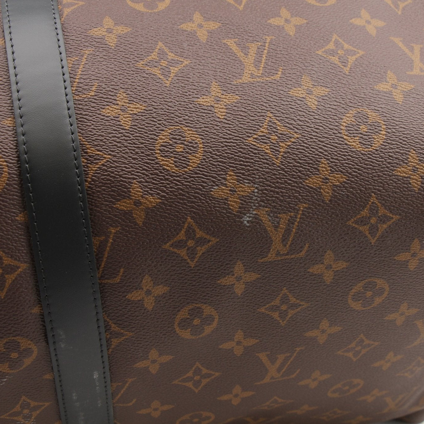 Louis Vuitton Keepall Bandoulière 55 travel bag by Gold & Beyond, showing the black monogram canvas with leather trim and straps.