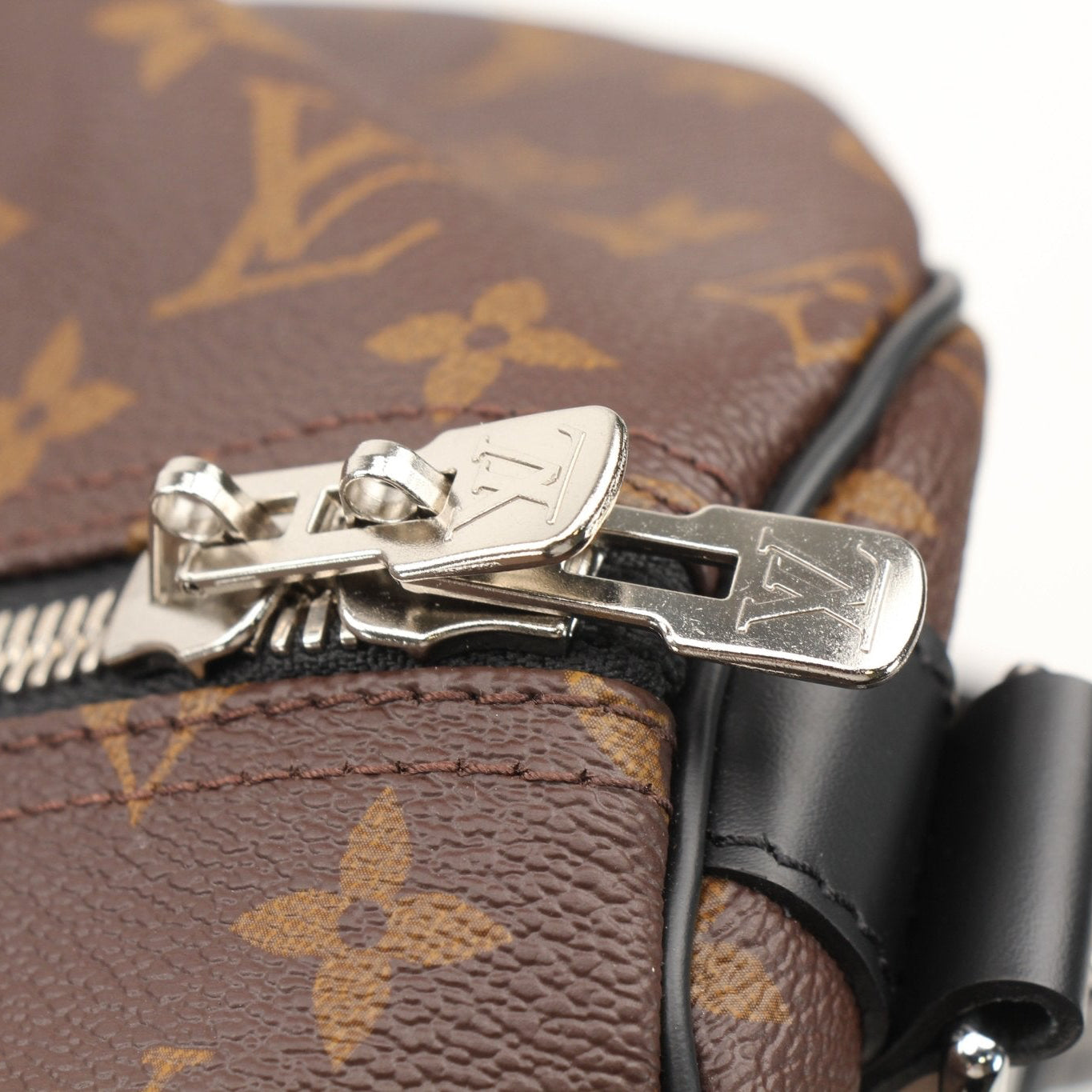 Gold & Beyond Louis Vuitton Keepall Bandoulière 55 travel bag with leather handles and spacious design, showing front view.