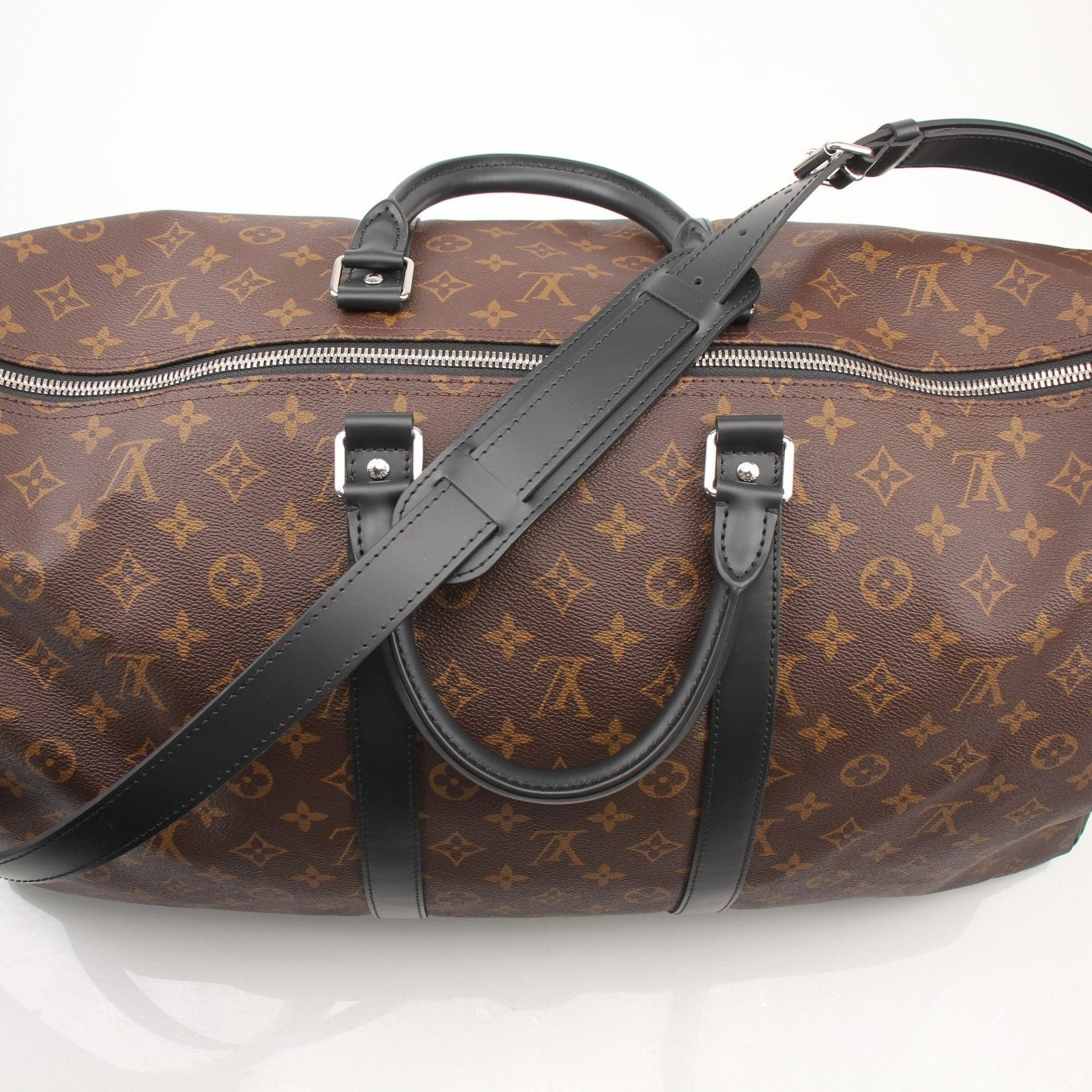 Louis Vuitton Keepall Bandoulière 55 travel bag in classic monogram canvas with leather accents, designed for stylish journeys.