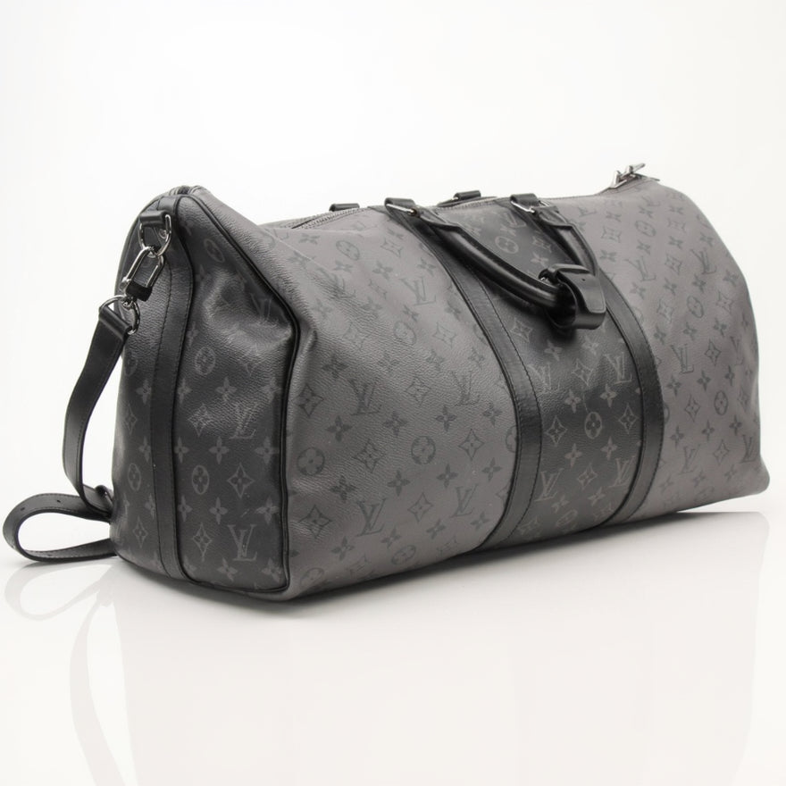 Louis Vuitton Keepall 50 Bandoulière travel bag in classic monogram canvas with leather trim and top handles.
