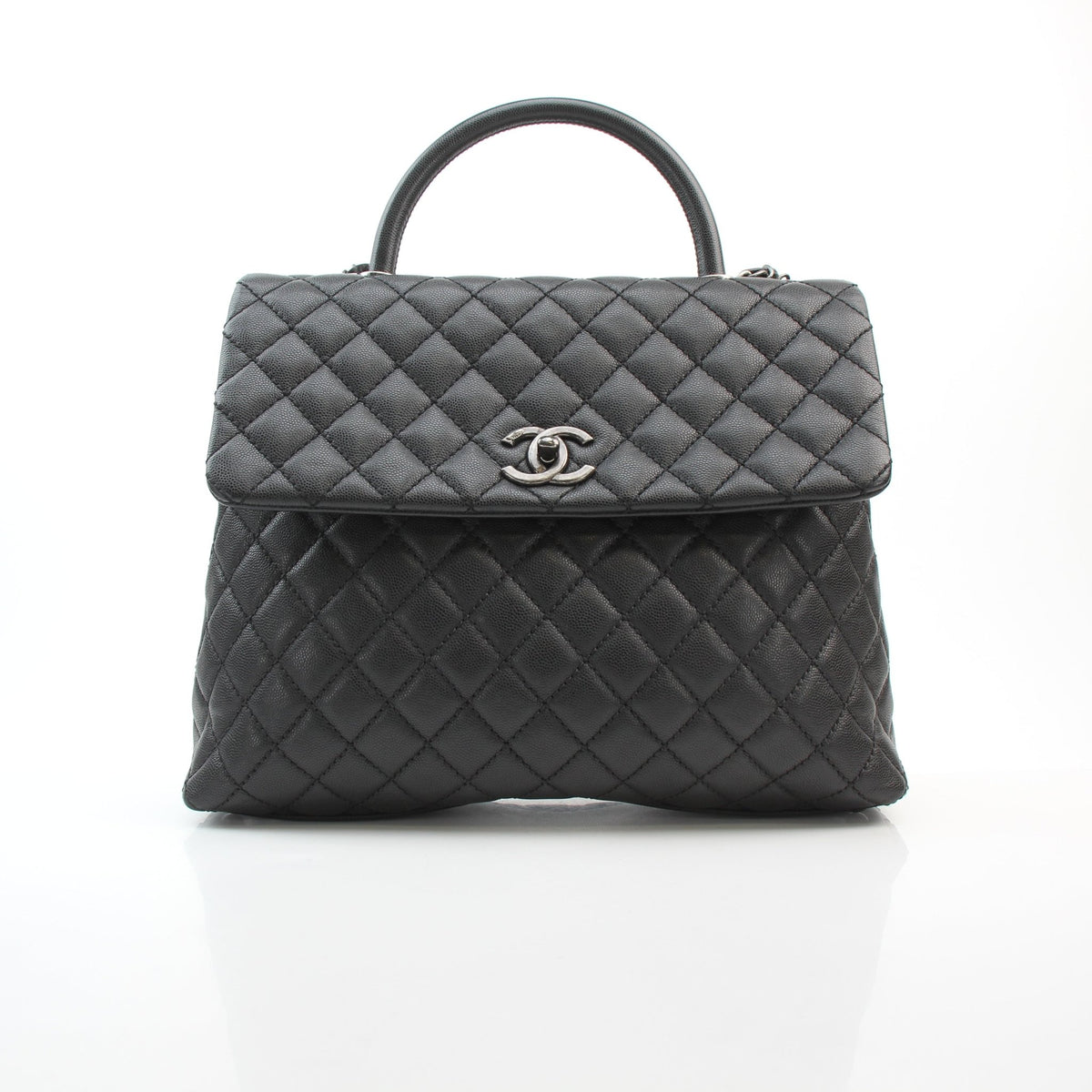 Chanel black caviar leather large Coco Handle flap handbag with structured top handle and chain strap