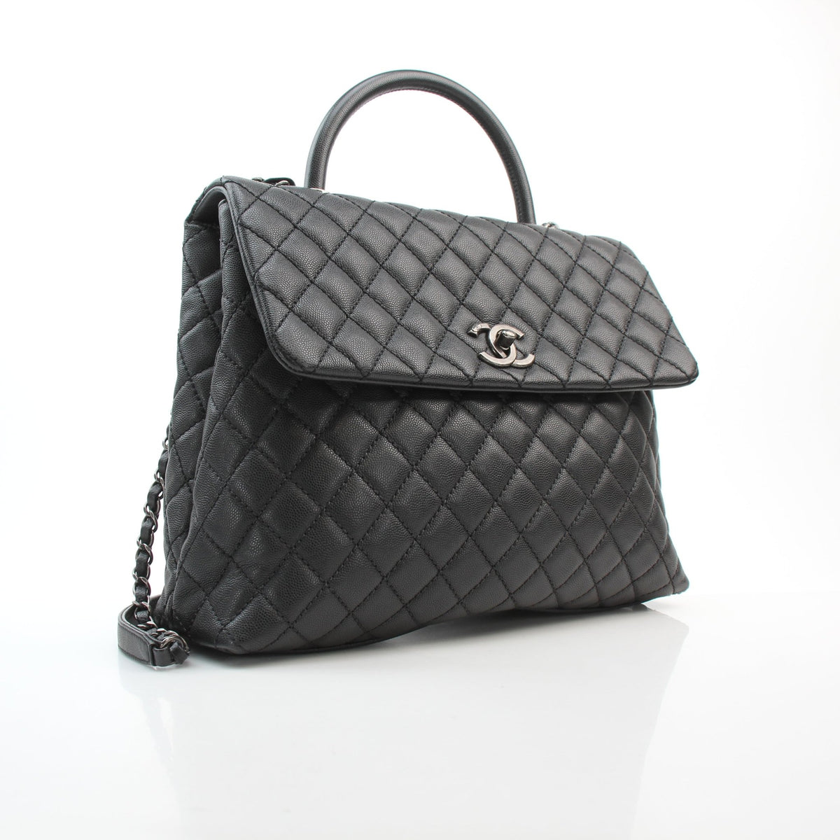 Chanel black caviar leather large Coco Handle flap handbag with structured top handle and chain strap