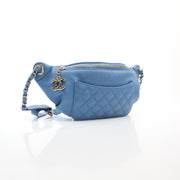 Blue lambskin leather bi-quilted classic waist bag by Chanel, shown front-facing with gold-tone hardware