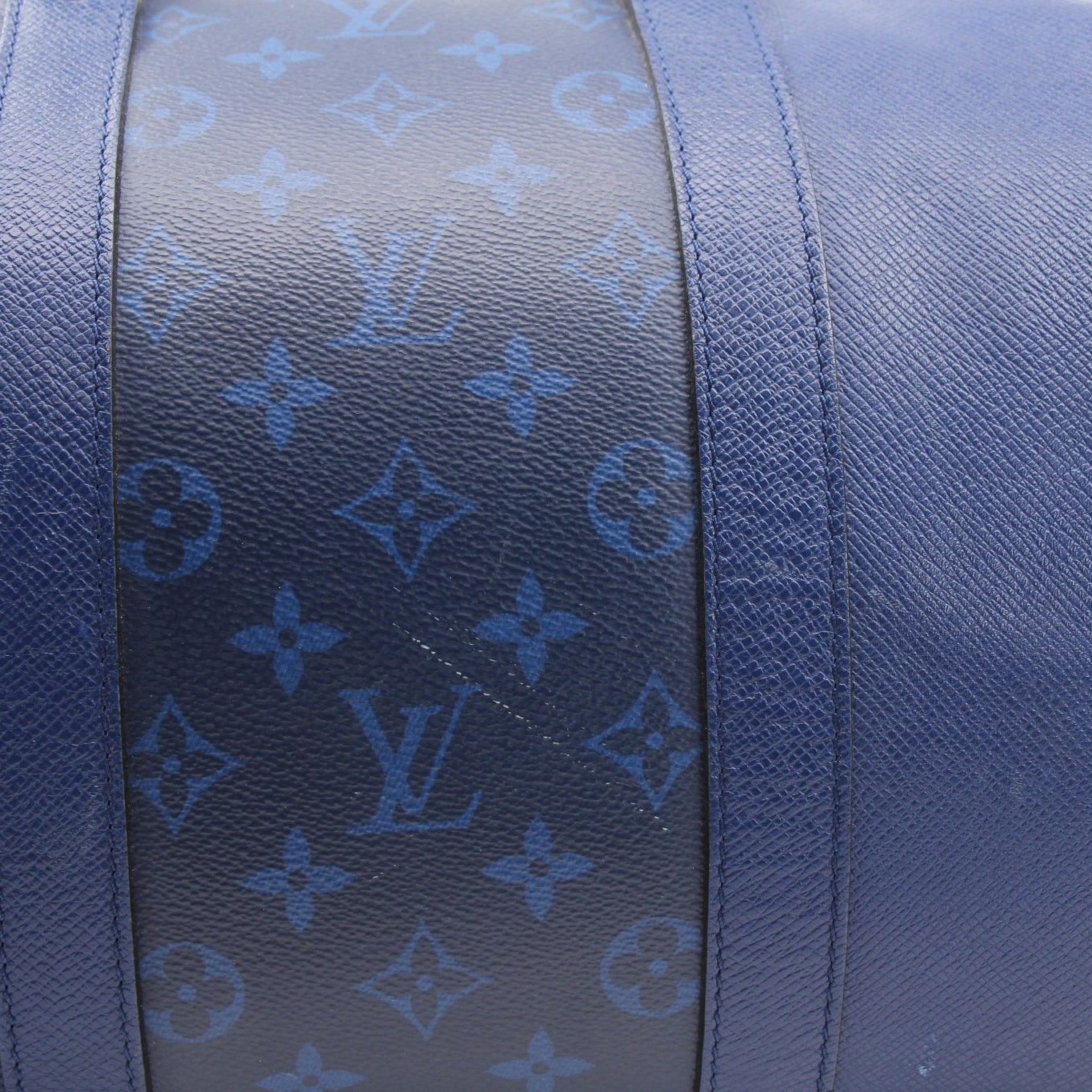 Louis Vuitton Blue Keepall 50 bandoulière duffle bag with leather handles and gold-tone hardware, designed for travel.