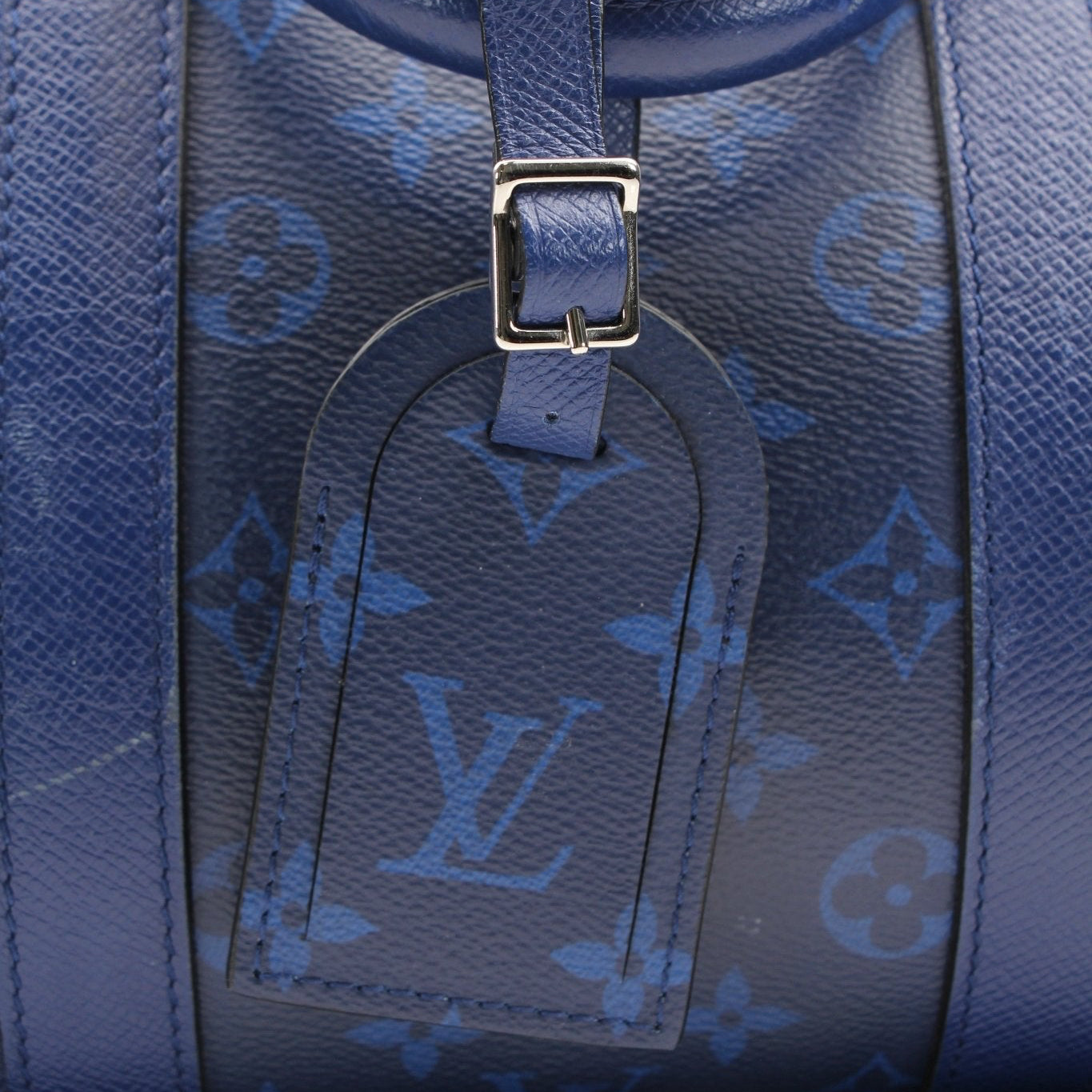 Blue Louis Vuitton Keepall 50 Bandoulière duffle bag with leather trim and gold hardware, designed for travel and stylish convenience.