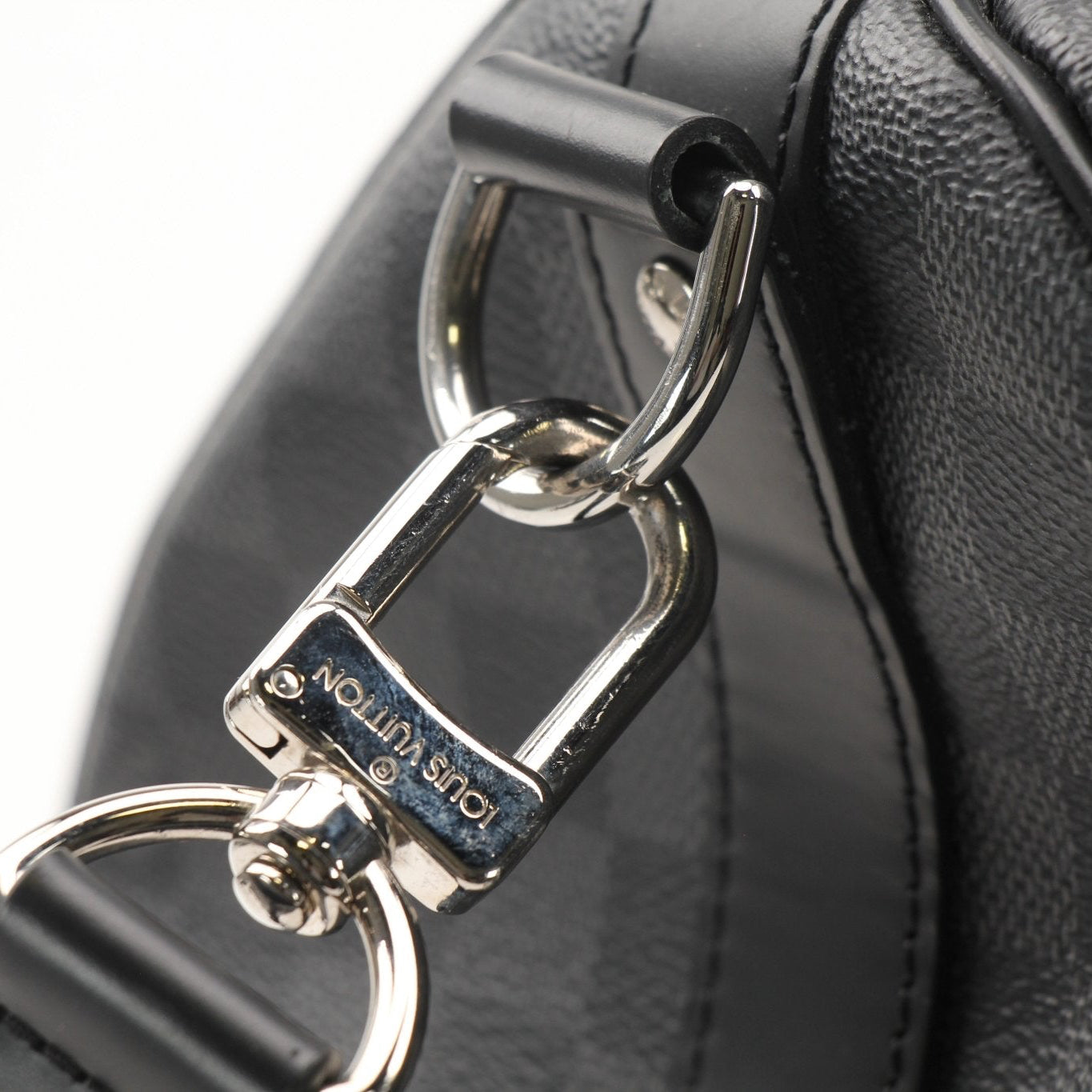 Gold & Beyond Louis Vuitton Keepall 45 Bandoulière duffle bag for travel, featuring signature monogram canvas and leather trim.