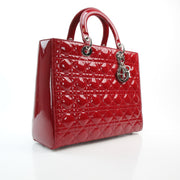 Red patent leather large Lady Dior handbag by Christian Dior with structured silhouette and top handles
