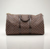 Louis Vuitton Keepall 50 Damier Ebene duffle bag in brown canvas with leather trim and handles, suitable for travel and weekend trips.