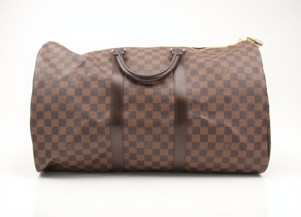 Louis Vuitton Keepall 50 Damier Ebene duffle bag with leather trim, zipper closure, and carry handles for travel.