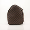 Louis Vuitton Keepall 50 Damier Ebene duffle bag with leather handles and gold hardware, perfect for travel.