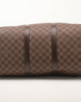 Louis Vuitton Keepall 50 Damier Ebene duffle bag with leather trim, shown in a travel bag image by Gold & Beyond
