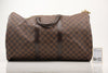 Louis Vuitton Keepall 50 Damier Ebene duffle bag with leather handles and gold hardware, designed for travel and weekend trips.