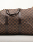 Louis Vuitton Keepall 50 Damier Ebene duffle bag with leather handles and gold hardware, designed for travel and weekend trips.