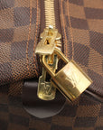 Louis Vuitton Keepall 50 Damier Ebene duffle bag for travel, featuring signature checkerboard pattern and leather handles.