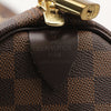 Louis Vuitton Keepall 50 Damier Ebene duffle bag with leather trim and handles, featuring signature checkered pattern and spacious travel design.