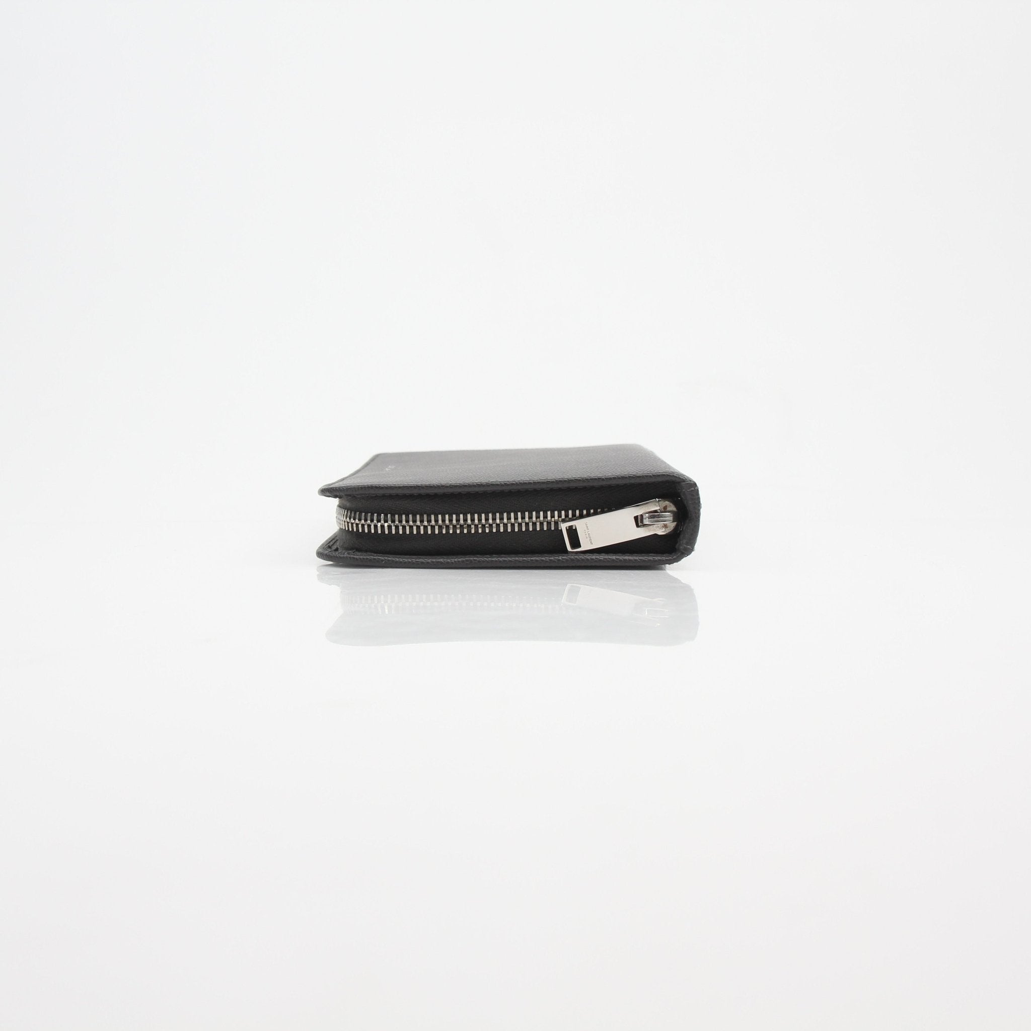 Gold & Beyond Saint Laurent Grain de Poudre leather zip wallet with visible zipper and textured leather surface.