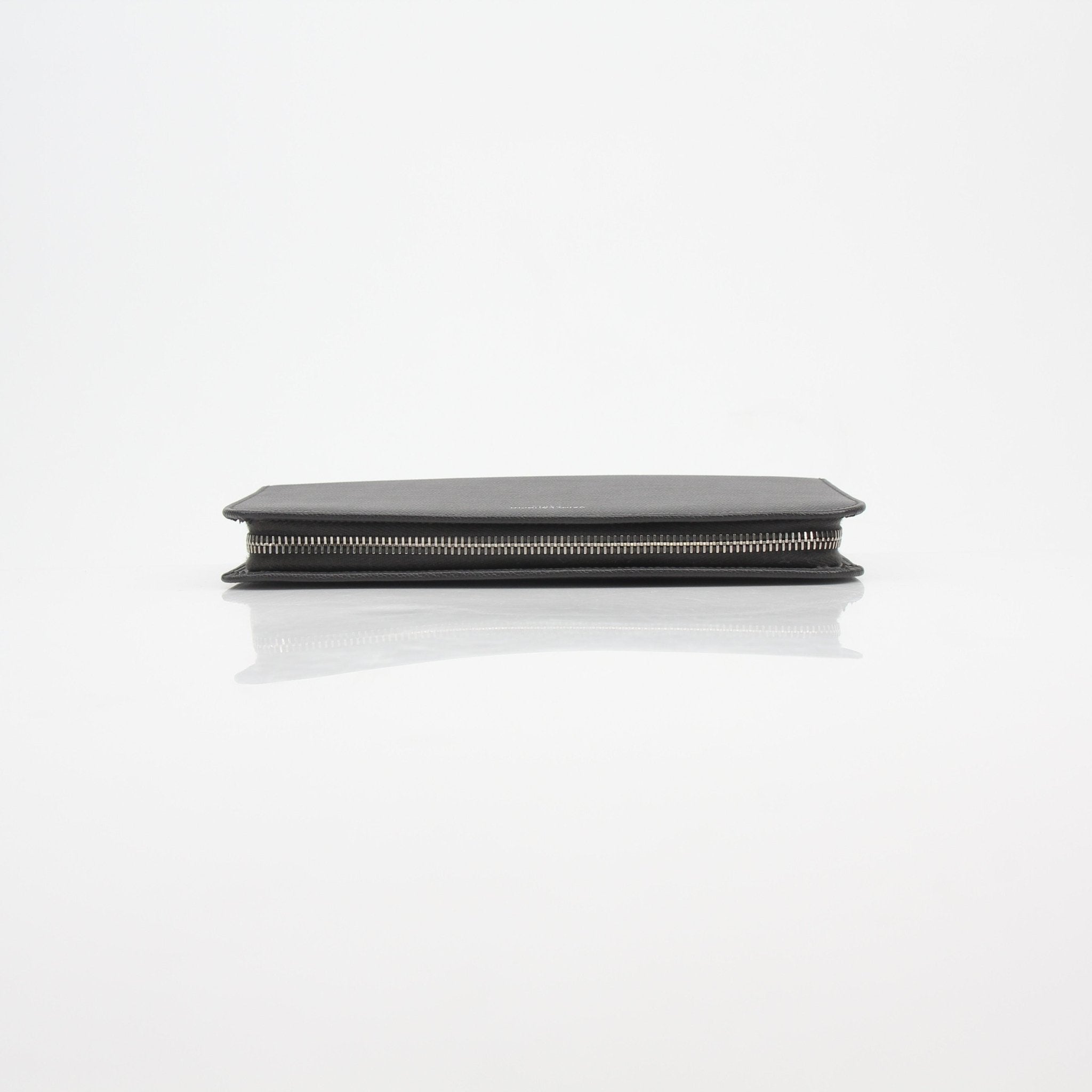 Saint Laurent Grain de Poudre leather zip wallet with gold-tone zipper and compact design, showcasing premium craftsmanship.