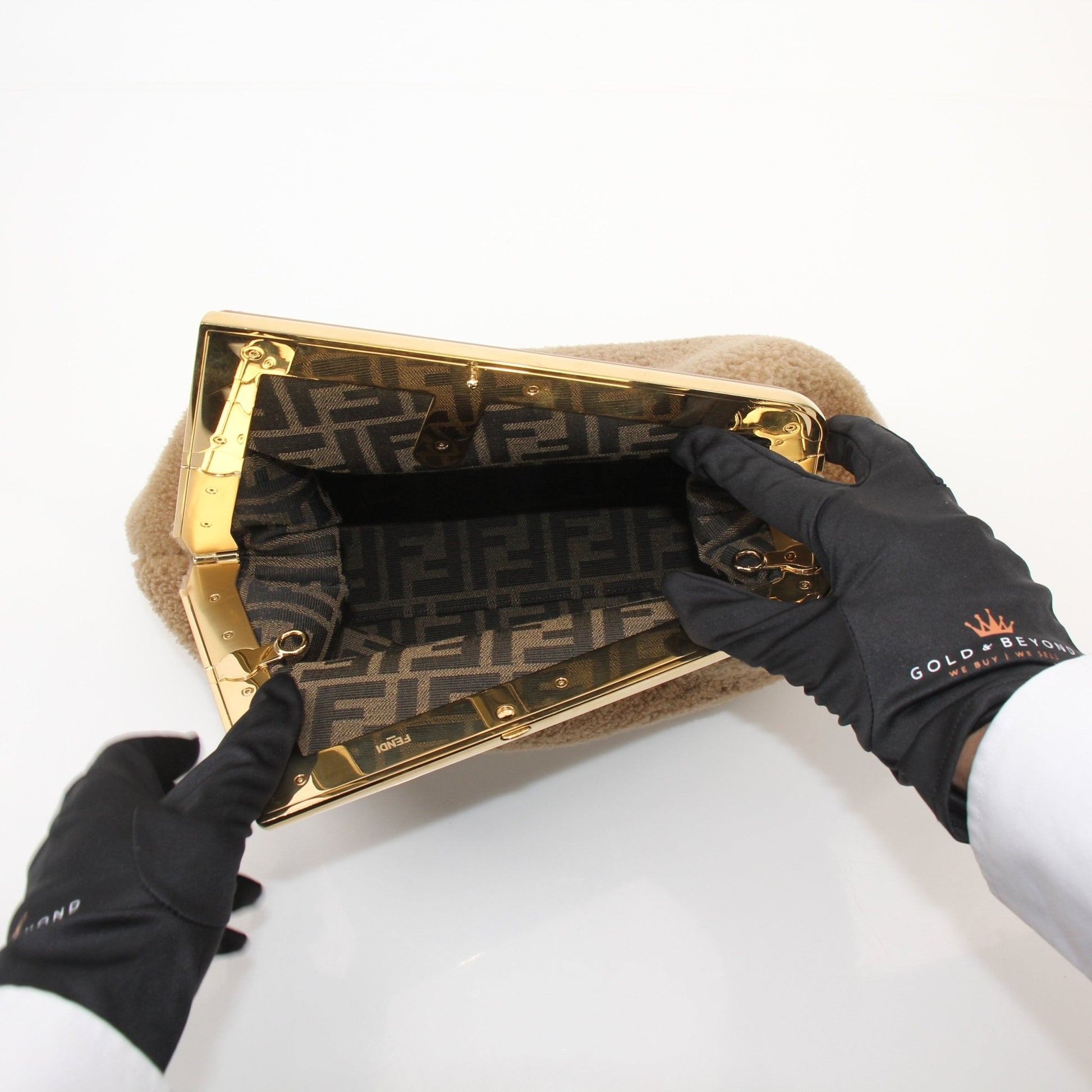 Gold & Beyond Fendi Shearling First Camel Handbag with leather accents and gold hardware, showcasing a luxurious handbag design.