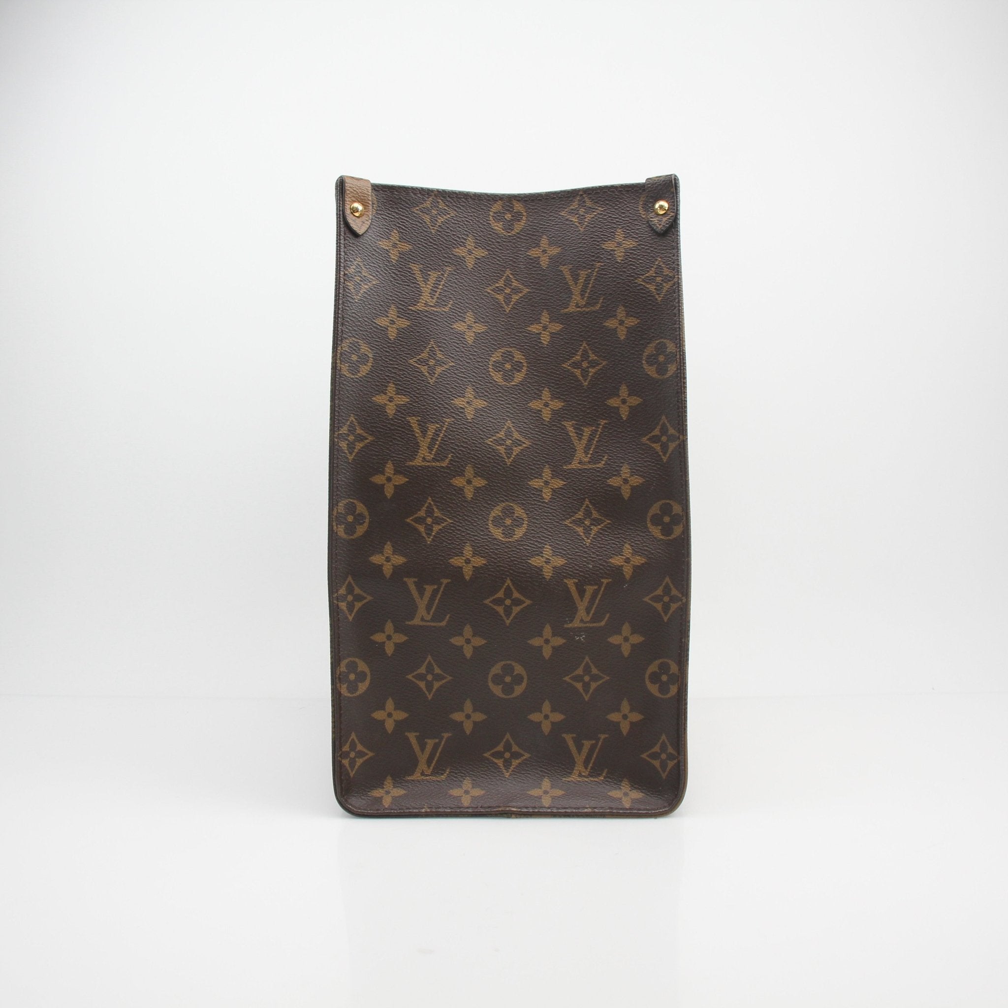 Louis Vuitton Reverse Monogram Giant OnTheGo GM tote handbag with leather handles and spacious interior, black and brown monogram pattern.
