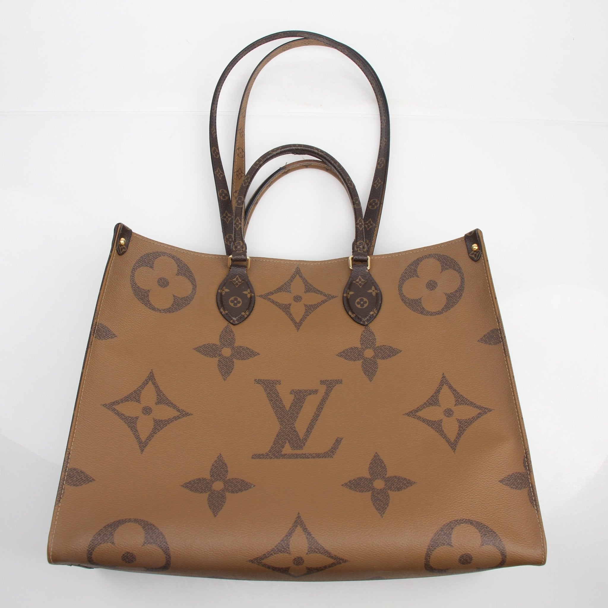 Gold & Beyond Louis Vuitton Reverse Monogram Giant OnTheGo GM tote handbag with double handles and spacious interior.