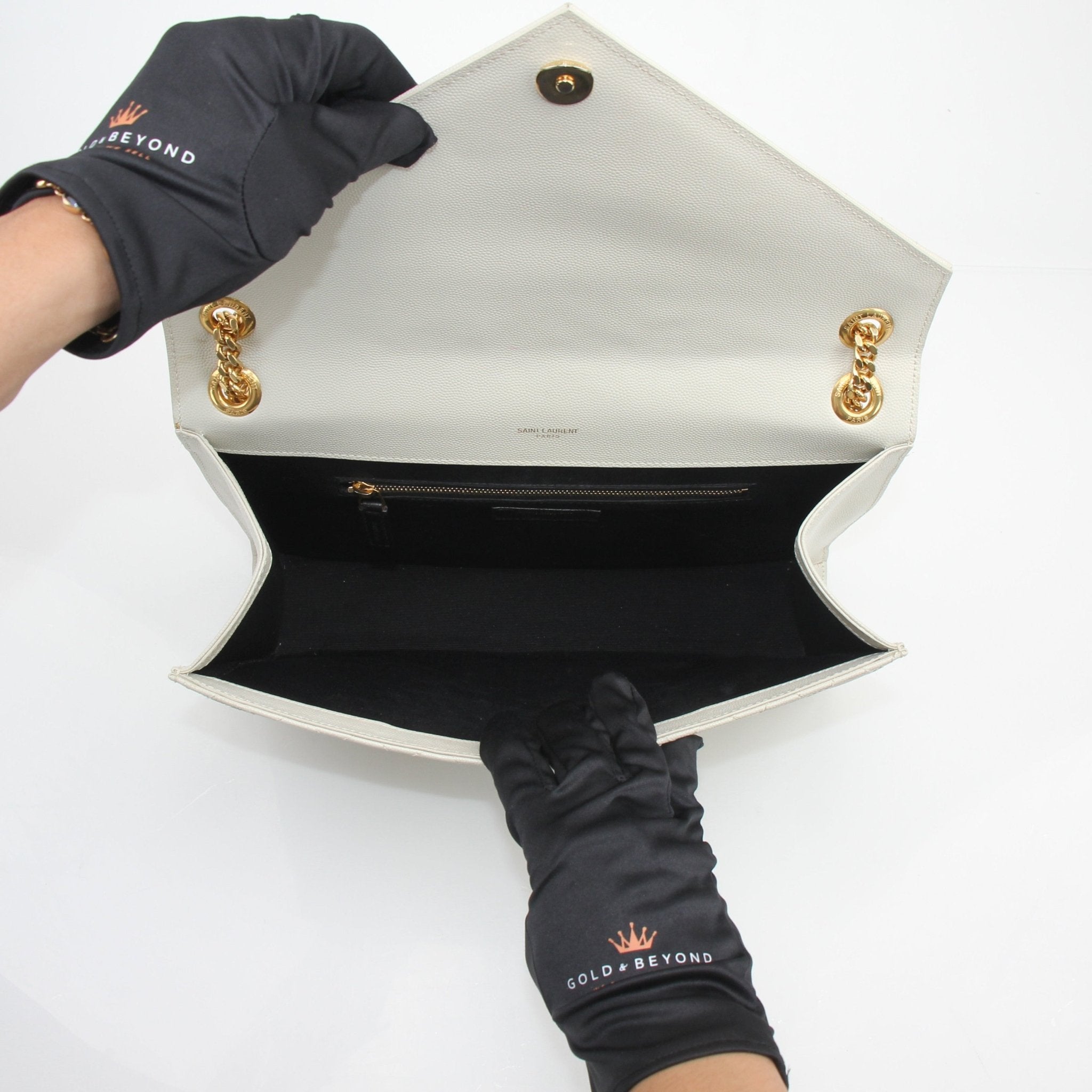 Gold & Beyond Saint Laurent Classic Monogram large envelope satchel handbag with gold logo and sleek design.